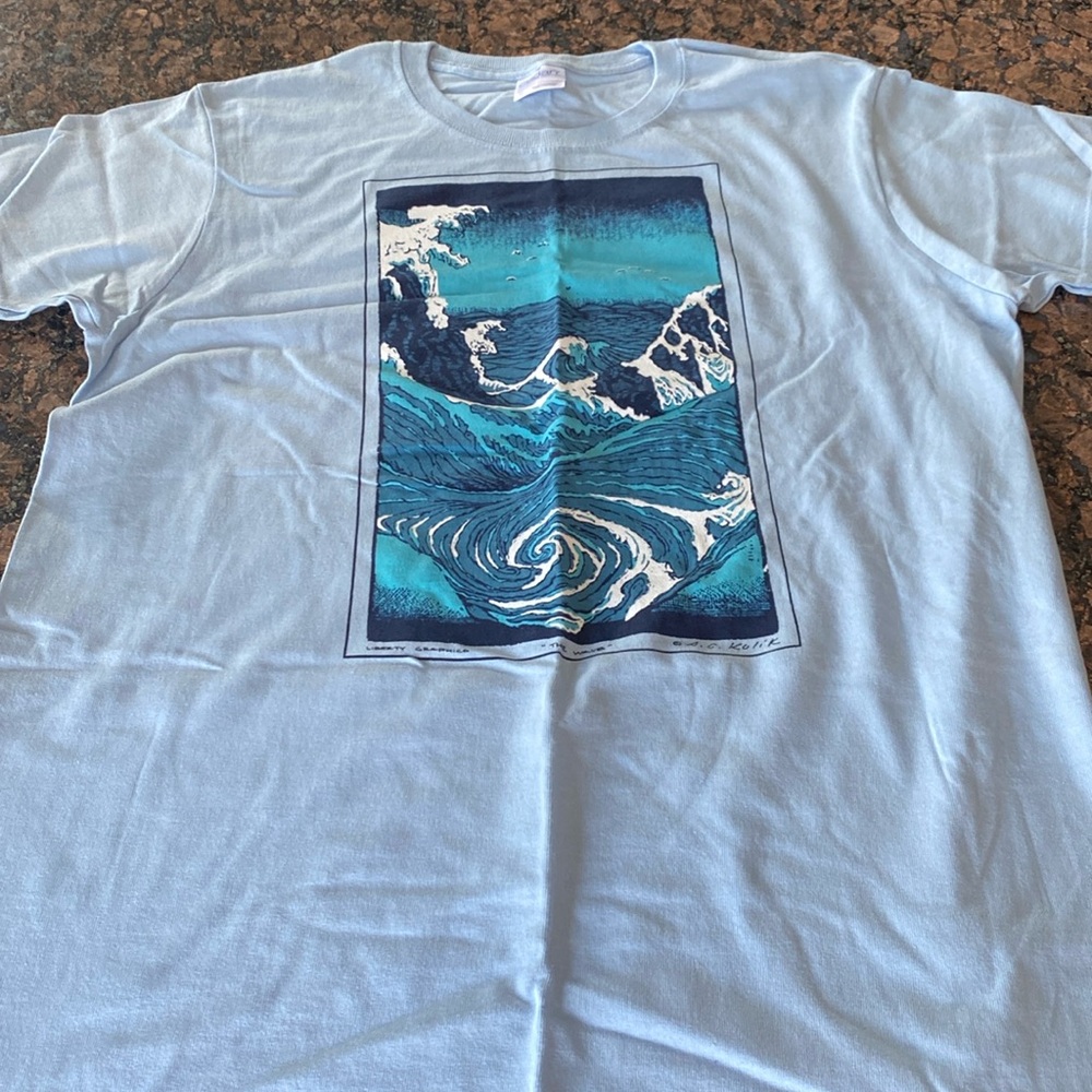 Women’s light blue T-shirt with wave emblem. Brand new!